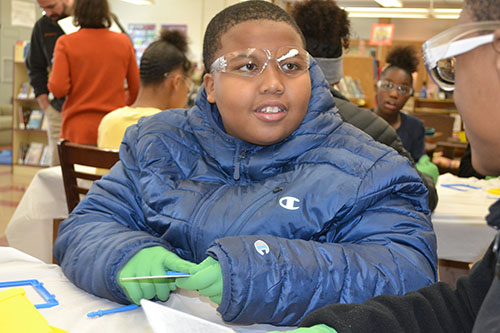 A Franklin student takes his Magnadoodle apart.