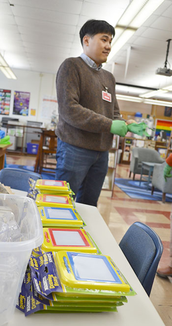 Kisung Kang prepares for Franklin students to enjoy the Destroy-a-Toy activity