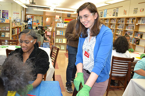 Physics’ Secondary Education Partnership Coordinator, Maggie Mahmood interacts with a Franklin STEAM Studio student.