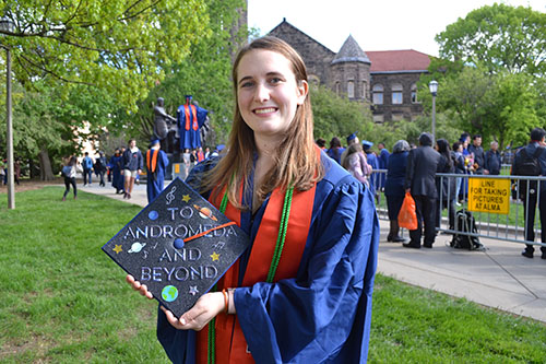 While getting some photos by Alma Mater during her May 2019 graduation, Katie Carroll shows off the decoration she made for her cap that revals one possible goal for her future: "To Andromeda and Beyond."