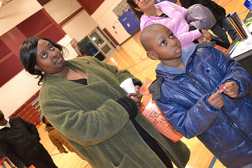 Shamari Graham and her son, John Whittle, wait expectantly to see if his raffle number is called.