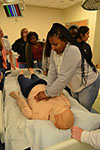 A BioE GAMES camper practices life-saving techniques on a dummy at the JUMP Simulation Education Center in Peoria. 