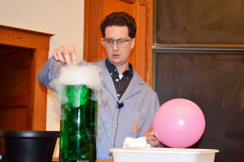 Christian Ray drops dry ice into a beaker  of green liquid to set the ambiance for the show.