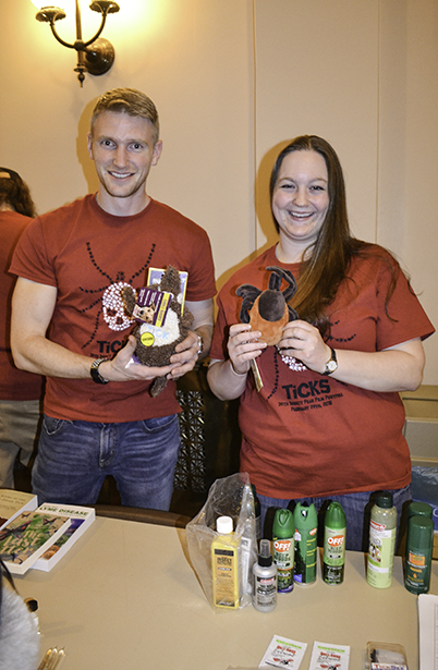 Entomology PhD students staffing the info table, which contained books, pamphlets, insecticides, even insect-related toys