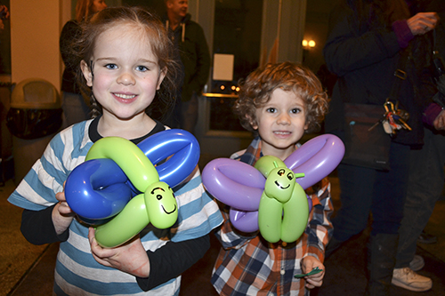 Two young visitors show off the balloon butterflies they got at the IFFF