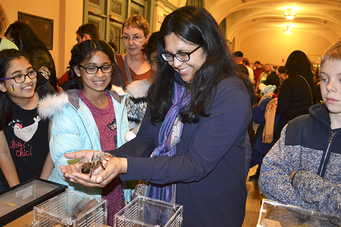 A mother overcomes her fears and holds a tarantula at the EGSA petting zo
