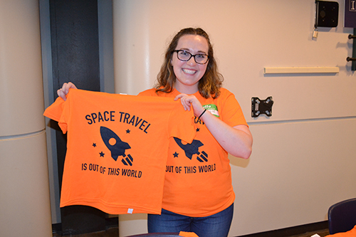 ISS PR manager Natalie Pfister shows off the t-shirt they designed for ISD.
