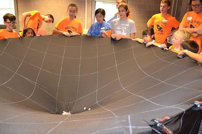Visitors at Illinois Space Day learn about ow orbits decay.
