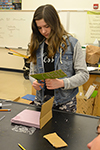 A Monticello Middle School student assembles her team's incubator.
