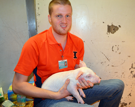 Neal Benjamin and 3-week-old pig.