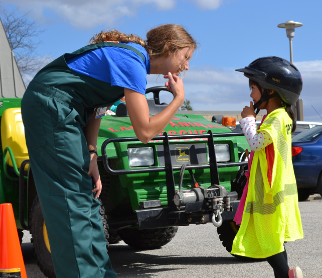 Vet Med student interacts with young visitor to the Large Animal Emergency Rescue station at the Vet Med Open House.