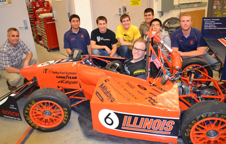 Mike Philpott (left) and members of the Formula SAE team pose with last year's Formula vehicle.