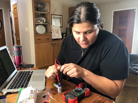 Darienne Ciuro Sanchez, a Dual Language science teacher at Urbana Middle School tests the charge on a battery during a beadboarding activity for the Catalyzing Inclusive STEM Experiences All Year Round (CISTEM365) 2021 Summer Institute, held in July.