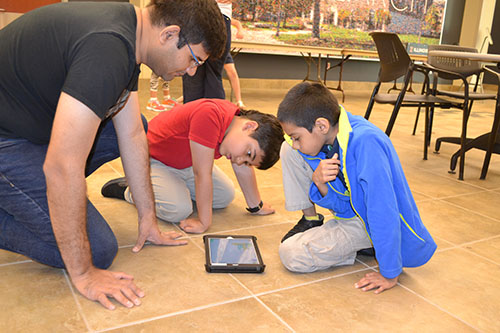 Mayank Boob helps IPA students program their Dash Robot. 