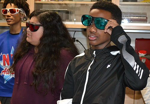 Frankin students visiting Profesor Gina Lorenz's lab on quantum optics, atomic/molecular spectroscopy, and optical magnetometry put on special glasses that will enable them to see certain kinds of light.