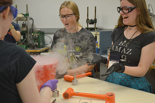 Madelyn Torrance (center) and her fellow GLAM campers have fun with liquid nitrogen. (Image courtesy of Sooah Park.)