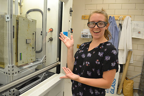 I-MRSEC undergrad Carmen Paquette shows off the furnace she revamped while researching the synthesis of an antiferromagnetic material this past summer in Professor Daniel Shoemaker's lab.