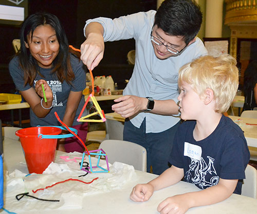 Left to right: Adriana Coariti and Jie Feng show a boy at the Orpheum how to make a bubble wand.
