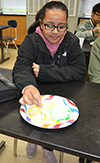 A local eighth grader learns about milk's hydrophobic and hydrophyllic properties.