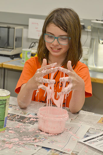 A  Mid-GLAM camper plays with some Oobleck she made during one of the hands-on activities.