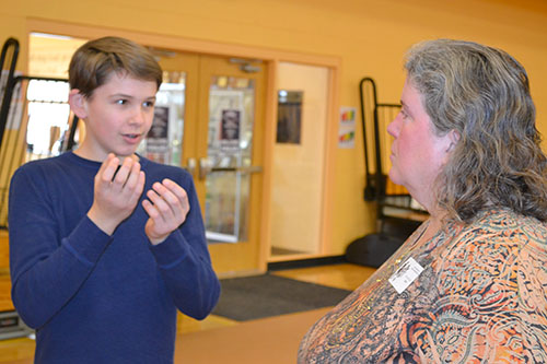 A Next Generation student explains his research to Lesley Deem, Program Manager of Illinois' Pollinatarium.
