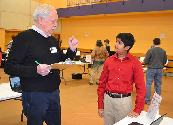 Bill Rose of Illinois' Applied Research Institute (left) discusses with an  NGS student  his research,