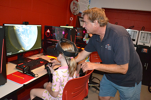 Jim Wentworth helps a student who's using Google Earth 360 to explore the Amazon.