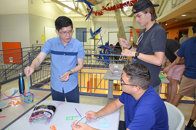 Jie Feng interacts with WYSE highschoolers about the 3D bubble wand he created.