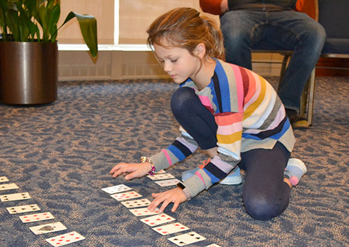 A young visitor works on the algorithm activity.