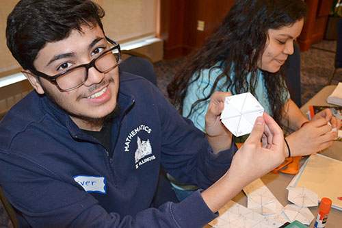 A math student shows  an example of a finished Hexaflexagon.