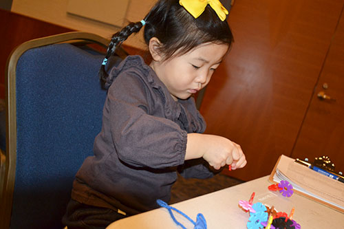 A young visitor does a hands-on activity during the Winter Math Carnival.