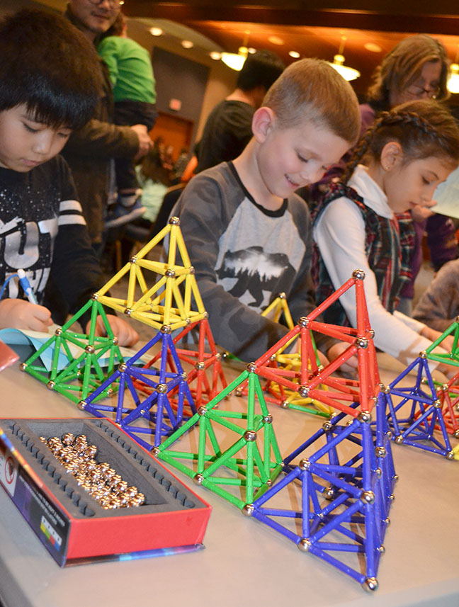 Young visitors build fractals at the Winter Math Carnival.