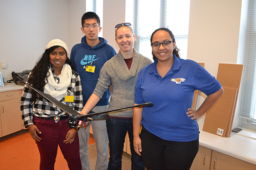 MechSE Assistant Professor Aimy Wissa (right) and her students show off the glider they brought to demonstrate to the fourth graders.