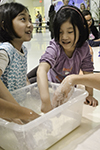 two girls play with oobleck