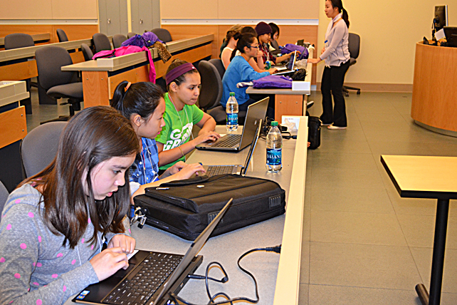 Young women use Scratch during the 'Make an Animation' workshop