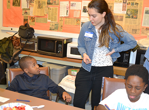 Ana Rosu interacts with a young African-American boy as a part of the Uni-DREAAM Connect Initiative's after-school program.