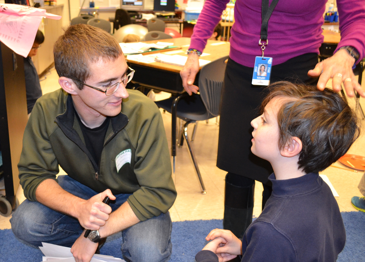 Dostart (left) and a fourth grader discuss the hands-on activity.