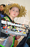 FLL contestant from Da Ex Bots holds some of his team's Lego equipment.
