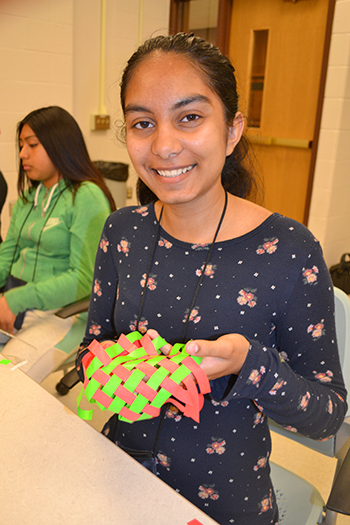 GLAM camper Mayher Matharu shows off the work she did for  her team's design project, incorporating tape. 