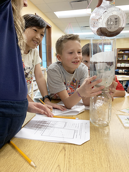 STEAM Studio 2019 students design a water filtration system for water that they found on their travels.