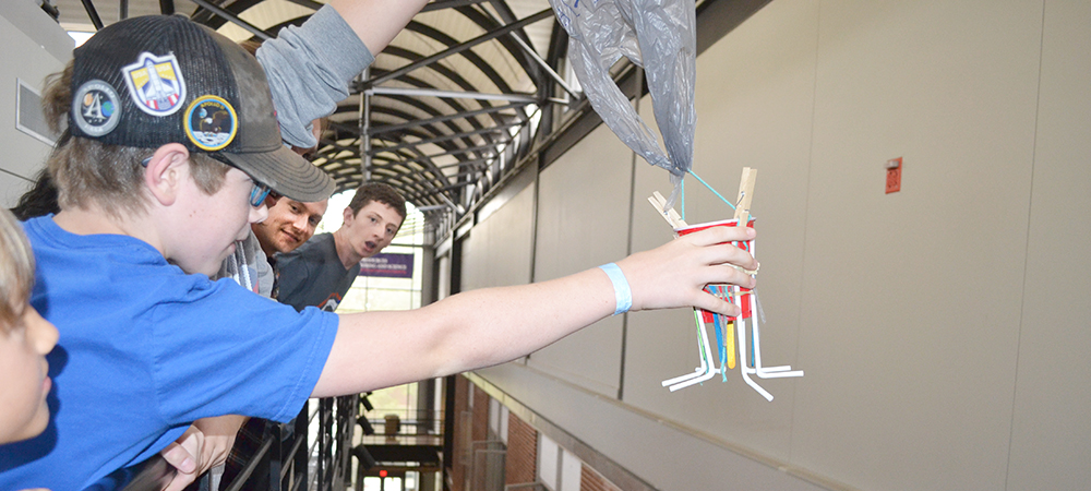 During Illinois Space Day 2019, a Mahomet Seymour 7th grader prepares to test his team's egg drop lander