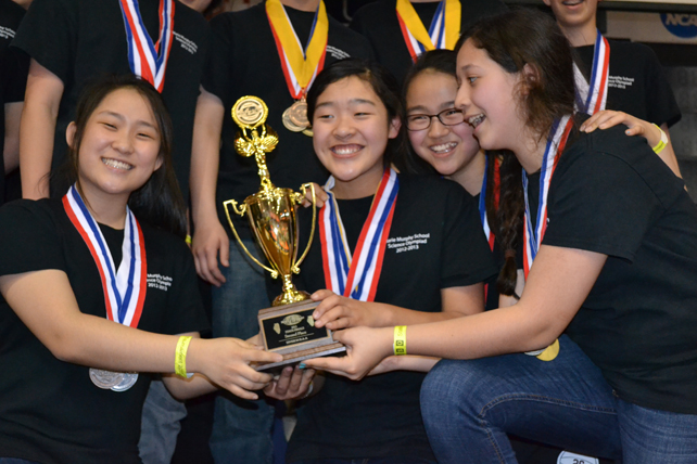Several Marie Murphy students celebrate over their trophy.