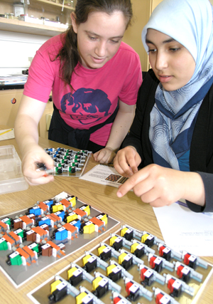 Two Uni High students working on DNA/RNA Lego kit.