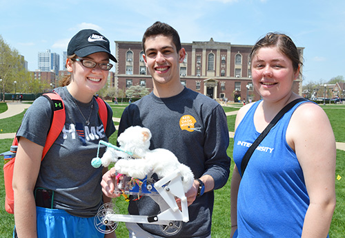 ME370 teammates Shydney Coker, Yoni Shapiro, and Elizabeth Jimenez display RoboCat, their teams' automaton