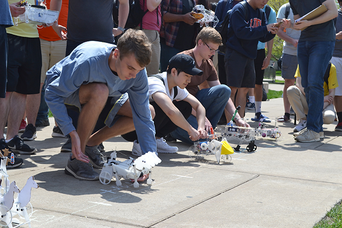 Spring 2018 ME370 students prepare to race their walkers during the end-of-the-semester March of the Automata competition.