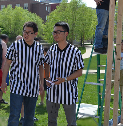 The two officials who referreed the competition look on as a team nears the end of their 5-minute practice session.