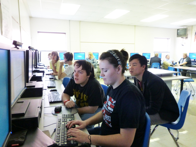 Kevin Wang (right) works with TEALS students in Kentucky.