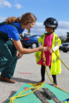 Vet Med student interacts with a young visitor to the Large Animal Emergency Rescue station during the fall 2013 Open House.