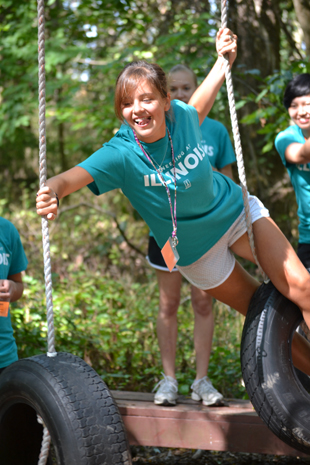 During the 2012 WIE Camp, a camper negotiates the "Tire Traverse" station on the challenge course.