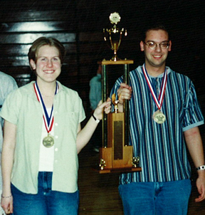 Jennifer Docktor and teammate holding North Dakota State Tournament trophy.